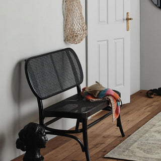 Blue fabric bench with three deep piped cushions on top and a dark wooden frame