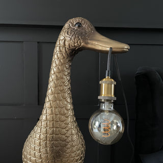 Large gold & brown duck floor lamp with a bulb hanging out it's mouth