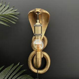 Gold snake wall light with a bulb in it's mouth